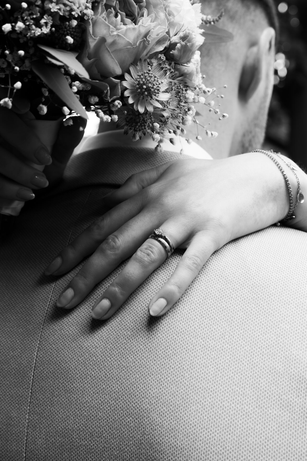 Hand mit Ring auf der Schulter des Bräutigams, Schwarzweiß